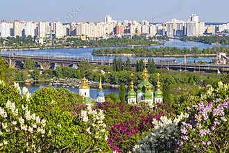 Cityscape of Kyiv with lilac blossom in spring