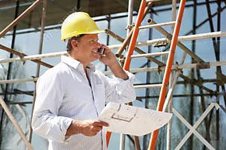 Architect With Plans Outside