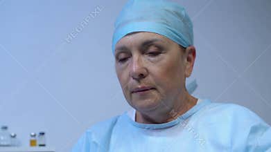 Exhausted female surgeon after hard operation, important profession, health