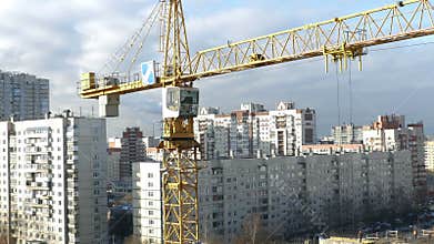 Tower crane over a construction site time lapse, zoom out