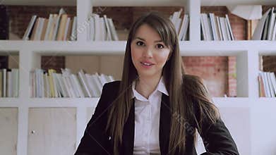 Confident young businesswoman speaking to camera at distant job interview