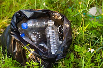 Trash bag and plastic bottle collect from around forest