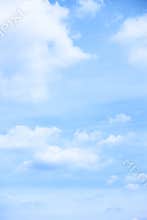 Pastel blue sky with light clouds