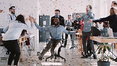 RED EPIC-W Happy young black businessman celebrating birthday at office workplace party with confetti slow motion.