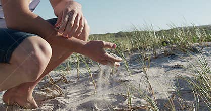 Man crouching on the beach