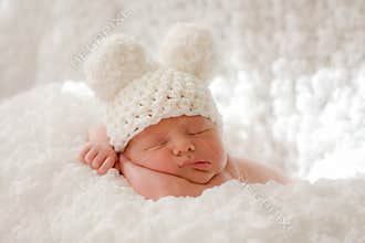 Sleeping newborn baby in knitted cap