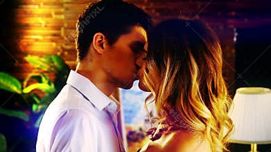 Slow motion kiss and embracing of young couple.