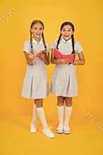 Sincere interest. Little girls with encyclopedia or childrens books. School library. Educational books for school