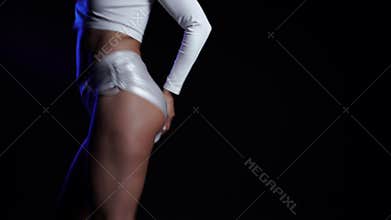 Sexy woman in short shorts dancing modern dance - twerk. Girl shaking, twerking