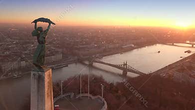 Budapest, Hungary - 4K aerial footage at sunrise of drone flying over of Statue of Liberty towards Liberty Bridge