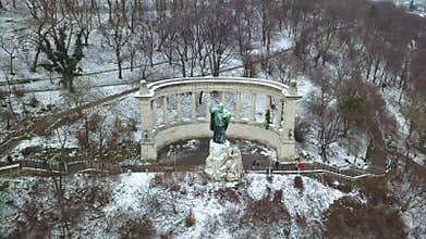 Budapest, Hungary - 4K aerial footage of drone flying away from the St.Gellert Bishop statue and memorial on a winter day