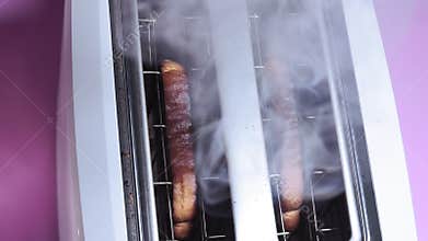 Burnt bread in the toaster close-up. making toast. smoke fire