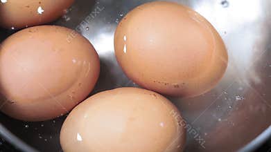 Boiled eggs close up in boiling water