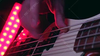 Close up of Hand Playing Electric Bass Guitar