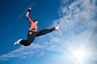 Sport woman jumping and fly over sky and sun