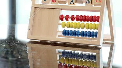 an alphabet abacus toy on bright, light background