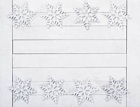 Christmas or New Years Snowflake Borders on White Wood Boards Background with copy space in the middle.  It`s horizontal but will