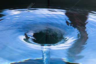 Water spiralling down a drain