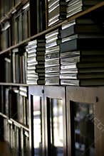 Bookshelves piled with books vertical