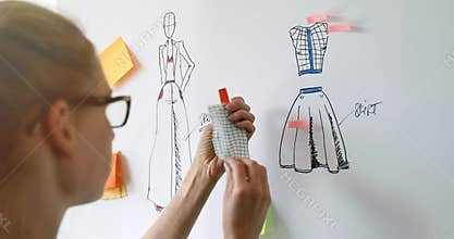Fashion designer choosing fabrics for her new clothing collection
