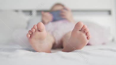 A close-up of children`s feet in the blood.