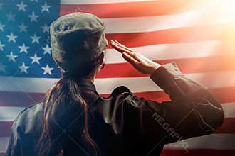 Veterans Day, Memorial Day, Independence Day. A female soldier salutes against the background of the American flag. Copy space.