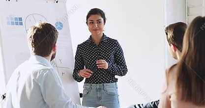 Happy trainer educating diverse people at office.