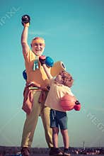 Grandfather and grandson with basketball ball and yoga mat in hands. Father and son having workout. Fathers day. Father