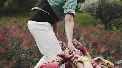 A close image of a human tower called `castellers` in catalan.