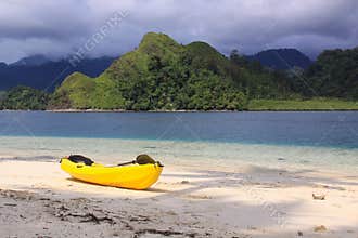 Yellow kayak on the beach of exotic tropical island