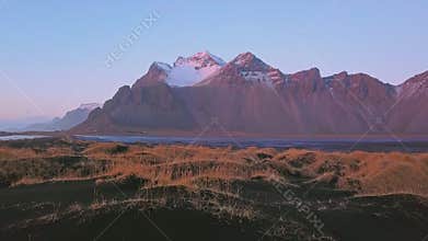 Aerial view drone flight forward,Vestrahorn mountain at sunset, Stokksnes, Iceland