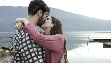 Couple dating and kissing at the lake