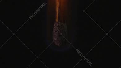 Close-up of a match being consumed by fire.