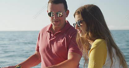 Side view of a Caucasian man and his teenage daughter fishing on boat