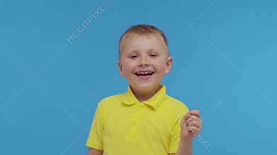 Portrait of happy smiling boy in t-shirt. Attractive and expressive kid in studio.