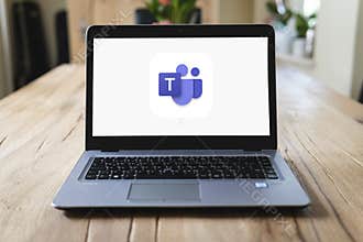 HP laptop on table with Microsoft Teams on screen