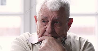 Worried unhappy middle aged older man grieving alone at home.