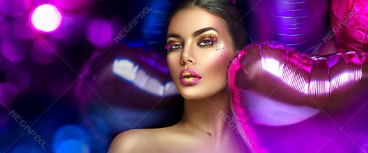 Beauty fashion model girl creative art makeup, over purple, pink and violet air balloons background. Woman face Make-up