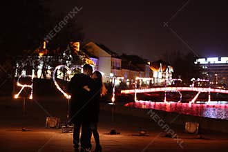 Young loving couple dancing on a night street