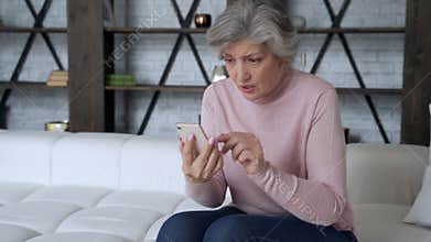 Old woman holding phone feeling excited about mobile win. Aged lady celebrate victory success read message good news.