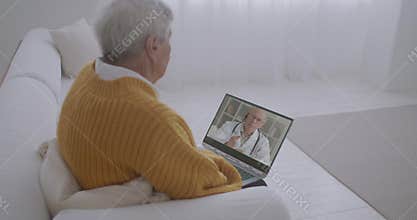 Modern distant health-related services, old man is staying home and consulting with doctor by video call, pandemic of