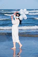 Woman with protective mask on the beach