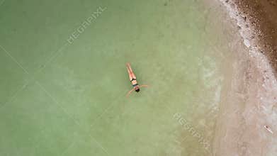 Woman bathes in the dead sea. Aerial video