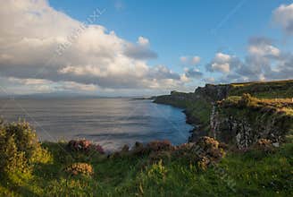 Kilt Rock, cliff, cloud and Lush grass in Isle of Skye, Scotland.