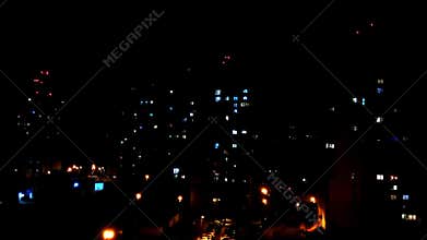 Lightning flashes at night in the city.