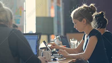 Young girls students are using laptops for research work at table in university campus irrl.