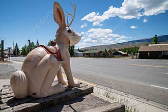 The Worlds Largest Jackalope statue at the gas station along the roadside. Wearing a mask due to