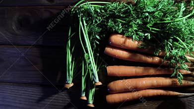 4k. A row of carrots on a rotating wooden table