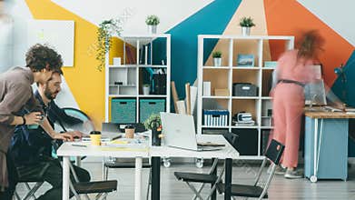Time lapse of ambitious youth business team working in office together