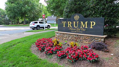 Camera pans to Entrance sign to Trump National Golf Club Charlotte